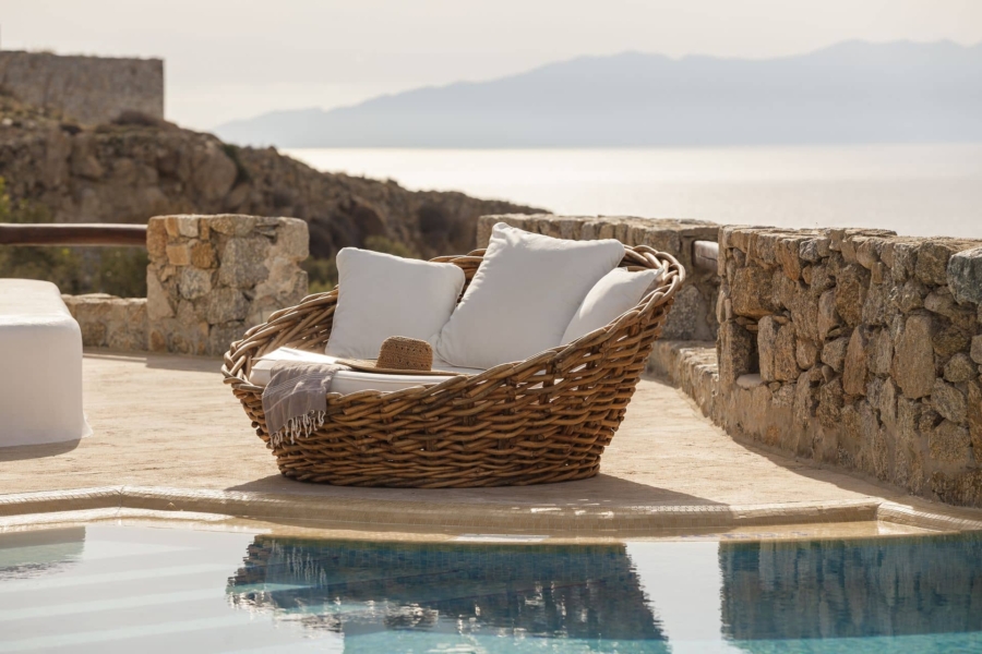 Comfy seat on the terrace by the pool of Villa Daphne, one the best luxury villas in Mykonos, Greece.